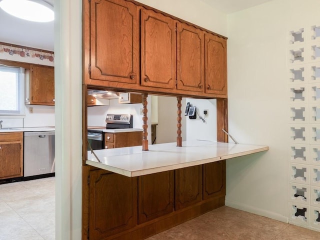 3 Brookland Farms Rd, Poughkeepsie, NY 12601 - kitchen with appliances with stainless steel finishes, brown cabinets, a peninsula, and light countertops