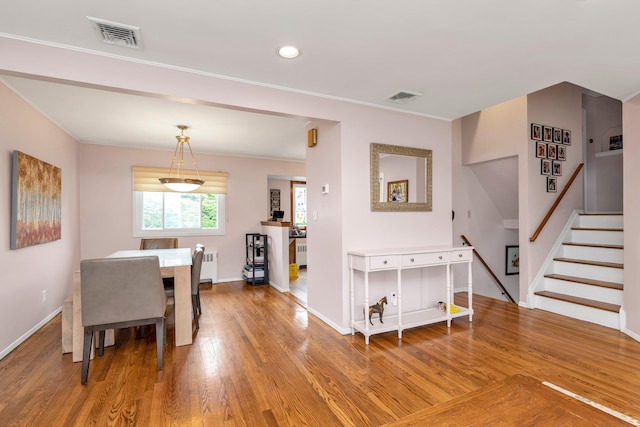 19 Alan Ct, Plainview, NY 11803 - dining room featuring radiator, light wood finished floors, stairway, baseboards, and ornamental molding