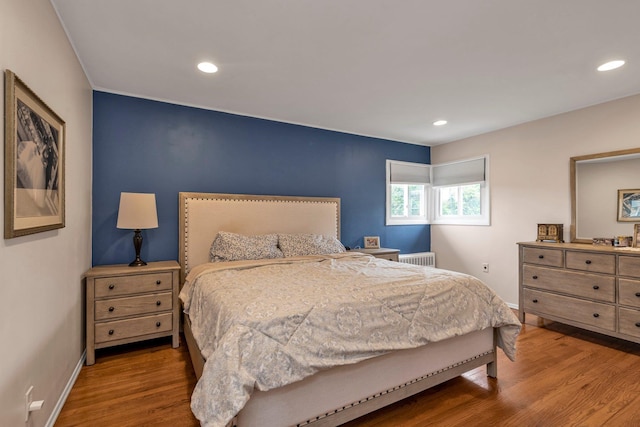 19 Alan Ct, Plainview, NY 11803 - bedroom featuring wood finished floors, baseboards, recessed lighting, and radiator
