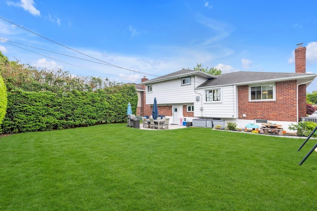 19 Alan Ct, Plainview, NY 11803 - back of property featuring a chimney, a hot tub, a patio, and a lawn