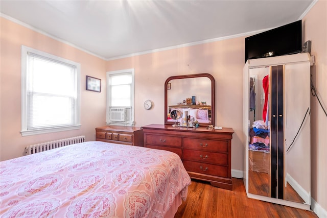 597 Stratford Rd, Baldwin, NY 11510 - bedroom featuring radiator, wood finished floors, ornamental molding, and baseboards