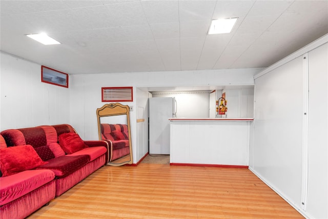 597 Stratford Rd, Baldwin, NY 11510 - living room with light wood finished floors and a dry bar