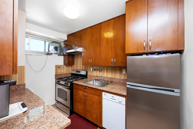 215 Park Row Unit 8B, New York Manhattan, NY 10038 - kitchen featuring stainless steel appliances, a sink, brown cabinets, and decorative backsplash