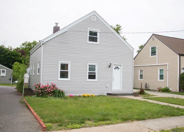 11 Shine Pl, Valley Stream, NY 11581 - view of front of home with a chimney and a front yard