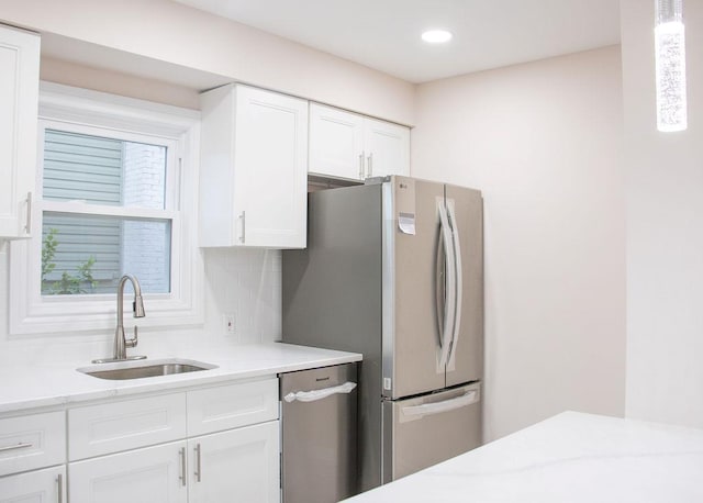 11 Shine Pl, Valley Stream, NY 11581 - kitchen with a sink, stainless steel appliances, white cabinetry, decorative backsplash, and recessed lighting