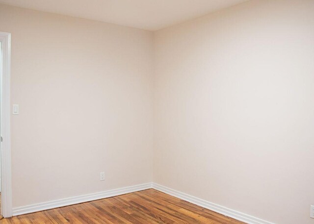 11 Shine Pl, Valley Stream, NY 11581 - unfurnished room with baseboards and wood finished floors