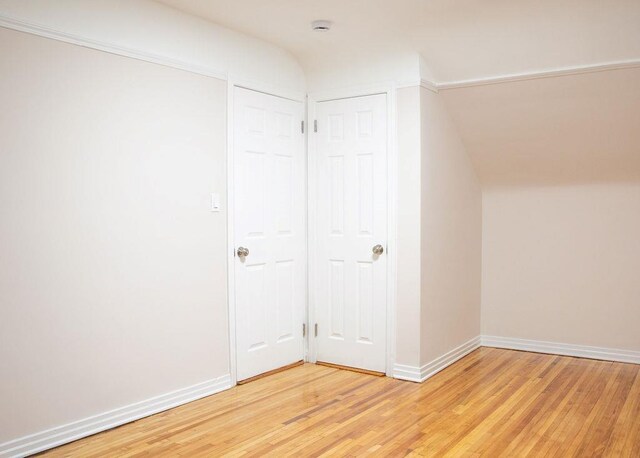 11 Shine Pl, Valley Stream, NY 11581 - additional living space with light wood-style floors, baseboards, and lofted ceiling