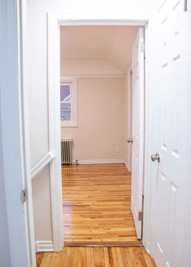 11 Shine Pl, Valley Stream, NY 11581 - hall with radiator, light wood finished floors, vaulted ceiling, and baseboards