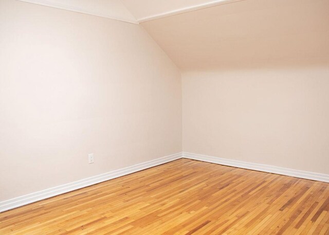 11 Shine Pl, Valley Stream, NY 11581 - spare room featuring lofted ceiling, light wood-type flooring, and baseboards