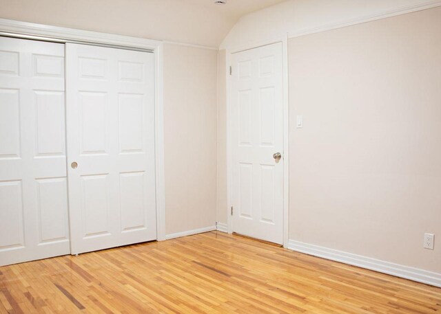 11 Shine Pl, Valley Stream, NY 11581 - unfurnished bedroom with light wood finished floors, baseboards, and vaulted ceiling