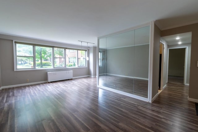 240 Garth Rd Unit 2G2, Scarsdale, NY 10583 - unfurnished bedroom with radiator, dark wood-type flooring, baseboards, a closet, and ornamental molding