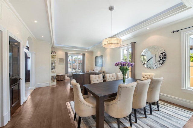 158-44 87th St, Howard Beach, NY 11414 - dining room featuring ornate columns, wood finished floors, crown molding, baseboards, and arched walkways