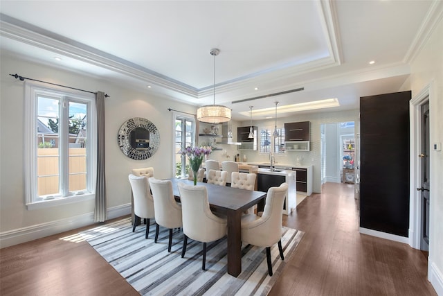 158-44 87th St, Howard Beach, NY 11414 - dining area featuring a raised ceiling, dark wood-style floors, baseboards, crown molding, and recessed lighting