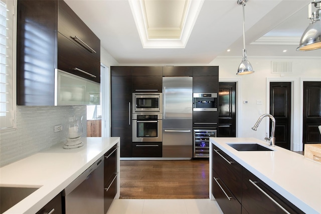 158-44 87th St, Howard Beach, NY 11414 - kitchen featuring built in appliances, a sink, modern cabinets, light countertops, and crown molding