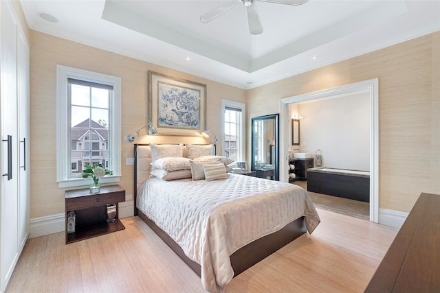 158-44 87th St, Howard Beach, NY 11414 - bedroom with a tray ceiling, baseboards, light wood finished floors, and a ceiling fan