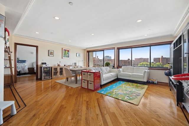 99-31 66th Ave Unit 5A, Rego Park, NY 11374 - living room with crown molding, healthy amount of natural light, light wood finished floors, a view of city, and recessed lighting