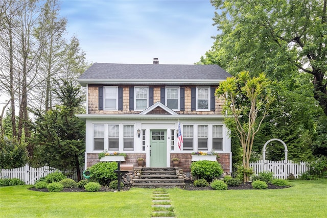 43 W 4th St, Locust Valley, NY 11560 - view of front of house featuring a chimney, a shingled roof, and stone siding