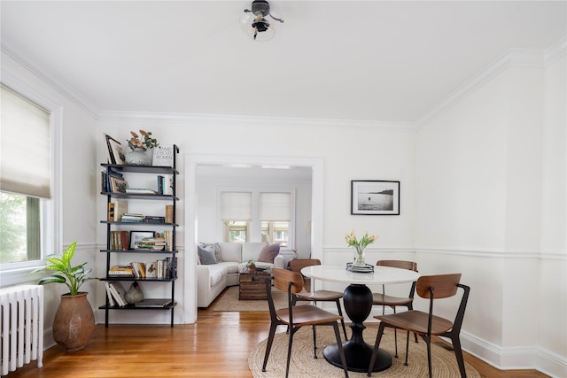 43 W 4th St, Locust Valley, NY 11560 - dining area with radiator heating unit, healthy amount of natural light, ornamental molding, and light wood-type flooring