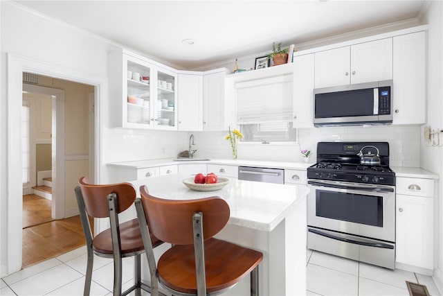 43 W 4th St, Locust Valley, NY 11560 - kitchen with stainless steel appliances, a sink, and light countertops