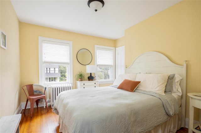 43 W 4th St, Locust Valley, NY 11560 - bedroom featuring radiator, hardwood / wood-style flooring, and baseboards