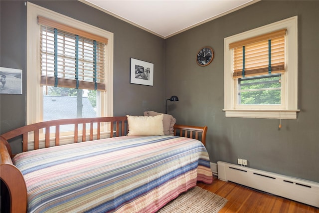 43 W 4th St, Locust Valley, NY 11560 - bedroom with baseboard heating, wood finished floors, and ornamental molding