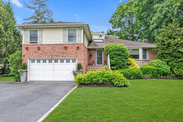22 Sunnyvale Rd, Port Washington, NY 11050 - tri-level home featuring asphalt driveway, a front lawn, a chimney, brick siding, and a garage