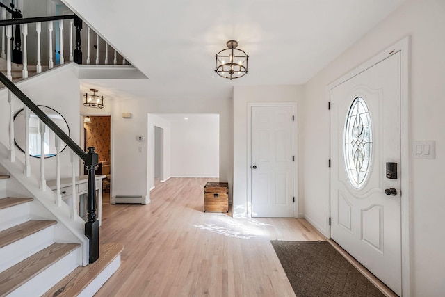 20 Vineyard Way, Mount Sinai, NY 11766 - foyer entrance featuring a chandelier, stairs, light wood-style floors, and baseboards