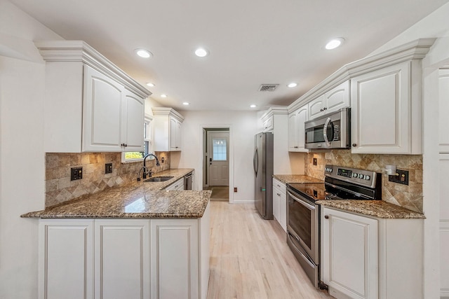 20 Vineyard Way, Mount Sinai, NY 11766 - kitchen with stainless steel appliances, a sink, stone counters, light wood-style floors, and recessed lighting