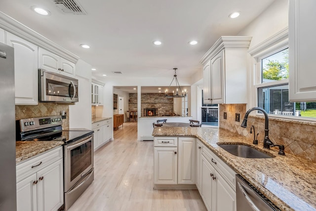 20 Vineyard Way, Mount Sinai, NY 11766 - kitchen with appliances with stainless steel finishes, a sink, a peninsula, white cabinetry, and recessed lighting