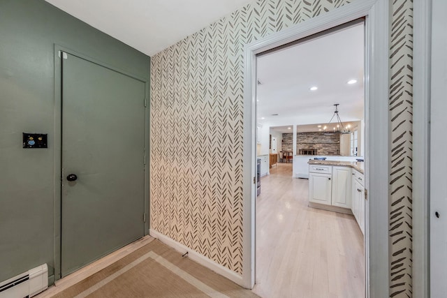 20 Vineyard Way, Mount Sinai, NY 11766 - bathroom with baseboard heating, wallpapered walls, a chandelier, wood finished floors, and vanity