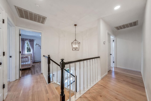 20 Vineyard Way, Mount Sinai, NY 11766 - hallway featuring an upstairs landing, light wood-type flooring, a chandelier, baseboards, and recessed lighting