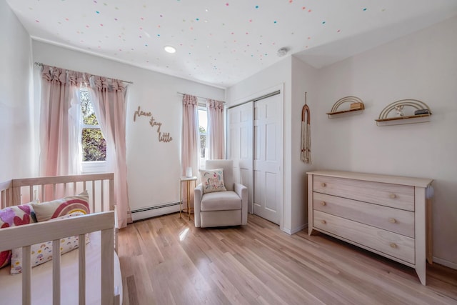 20 Vineyard Way, Mount Sinai, NY 11766 - bedroom featuring baseboard heating, light wood-type flooring, recessed lighting, and a closet