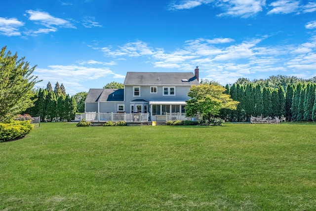 20 Vineyard Way, Mount Sinai, NY 11766 - rear view of property with a chimney, a yard, a sunroom, and a deck
