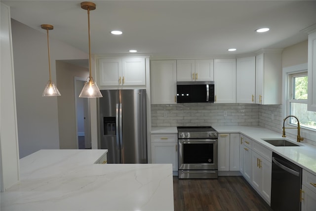 352 Bay Ave, Patchogue, NY 11772 - kitchen featuring appliances with stainless steel finishes, a sink, dark wood-style flooring, tasteful backsplash, and white cabinetry