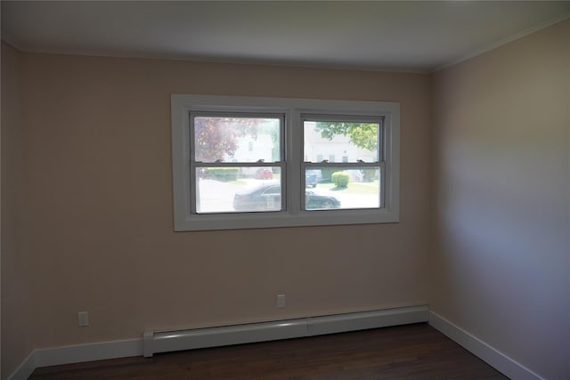 352 Bay Ave, Patchogue, NY 11772 - spare room with baseboard heating, dark wood finished floors, baseboards, and ornamental molding