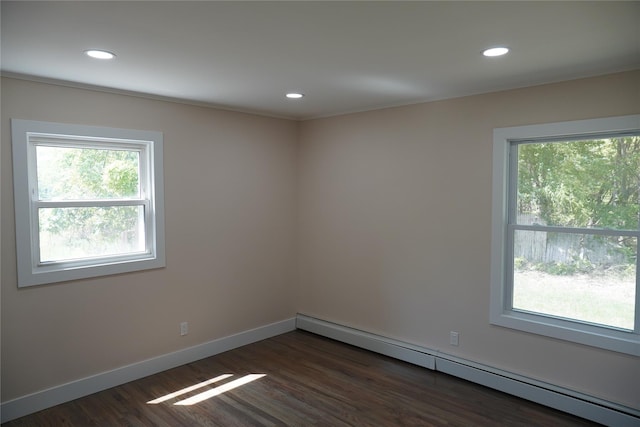 352 Bay Ave, Patchogue, NY 11772 - spare room with baseboard heating, dark wood-style floors, recessed lighting, and baseboards