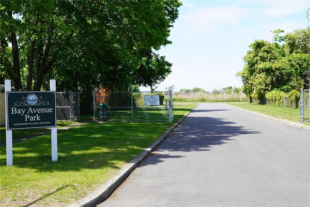 352 Bay Ave, Patchogue, NY 11772 - view of asphalt road with curbs and a gate