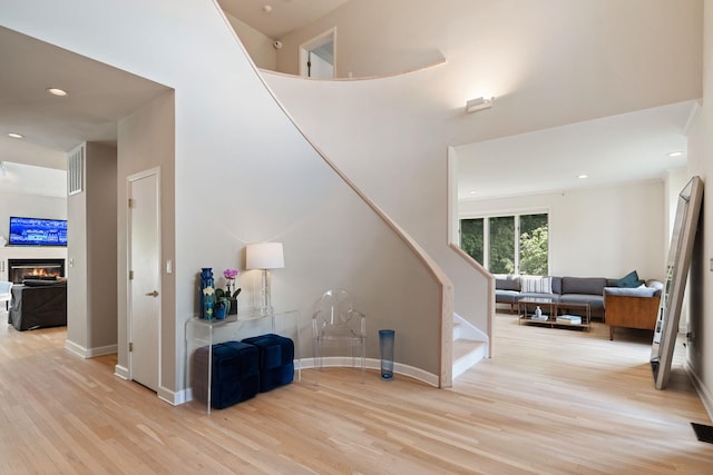 43 Random Farms Cir, Chappaqua, NY 10514 - stairs with wood finished floors, a glass covered fireplace, and recessed lighting