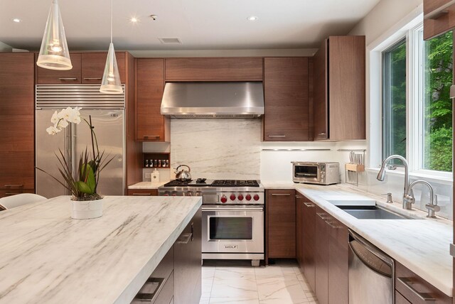 43 Random Farms Cir, Chappaqua, NY 10514 - kitchen featuring wall chimney range hood, high end appliances, light marble finish flooring, healthy amount of natural light, and recessed lighting
