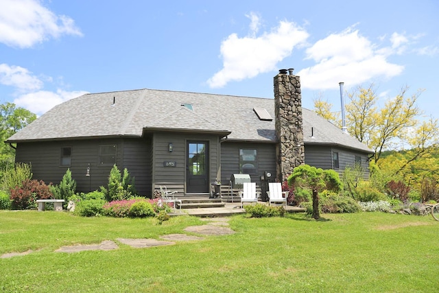 605 Dutch Hill Rd, Call Listing Agent, NY 12776 - rear view of house featuring a yard, a chimney, entry steps, and roof with shingles