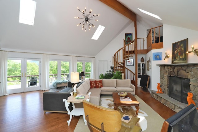 605 Dutch Hill Rd, Call Listing Agent, NY 12776 - living room with high vaulted ceiling, a skylight, stairs, a stone fireplace, and wood finished floors