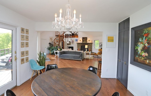 605 Dutch Hill Rd, Call Listing Agent, NY 12776 - dining room with dark wood-type flooring, a chandelier, a fireplace, and baseboards