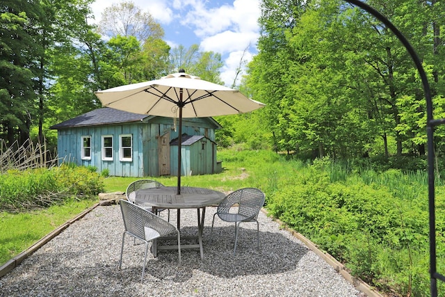 605 Dutch Hill Rd, Call Listing Agent, NY 12776 - view of patio with an outbuilding and outdoor dining space