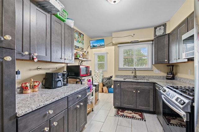 37 Prospect St, Garnerville, NY 10923 - kitchen featuring stainless steel appliances, dark brown cabinetry, light tile patterned floors, and light stone countertops