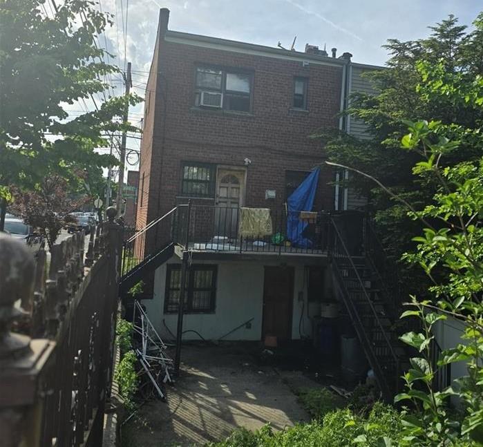 3724 Barnes Ave, Bronx, NY 10467 - rear view of property with stairs, brick siding, and a deck