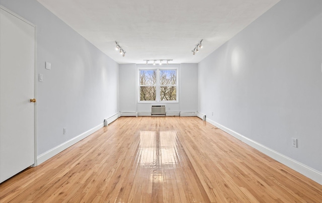 42-30 Douglaston Pkwy Unit 7H, Douglaston, NY 11363 - empty room with track lighting, light wood-style flooring, and baseboards