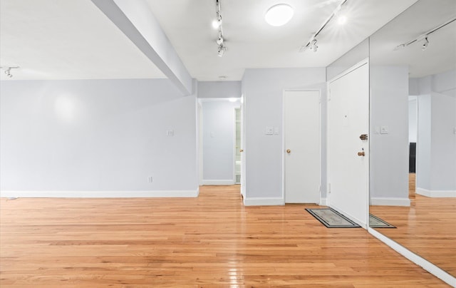 42-30 Douglaston Pkwy Unit 7H, Douglaston, NY 11363 - foyer entrance featuring track lighting, light wood-type flooring, and baseboards
