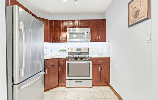 42-30 Douglaston Pkwy Unit 7H, Douglaston, NY 11363 - kitchen featuring stainless steel appliances, decorative backsplash, and light countertops