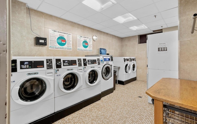 42-30 Douglaston Pkwy Unit 7H, Douglaston, NY 11363 - community laundry room featuring tile walls and separate washer and dryer