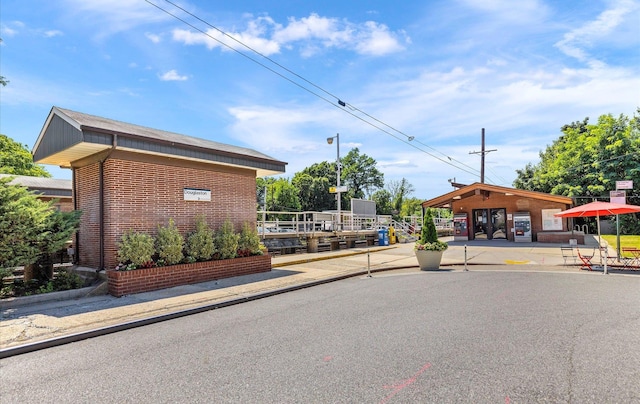 42-30 Douglaston Pkwy Unit 7H, Douglaston, NY 11363 - view of asphalt road featuring curbs and sidewalks